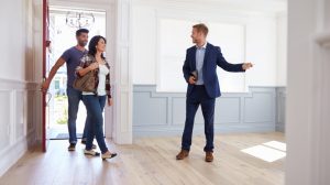 Realtor Showing Hispanic Couple Around New Home
